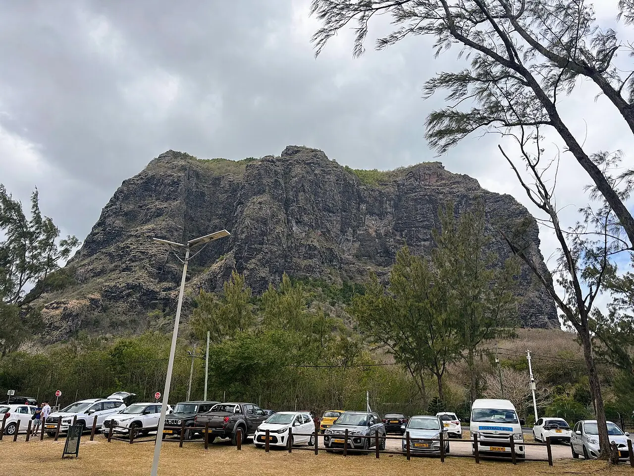 Cars parked at Le Morne Brabant public beach car park in Mauritius