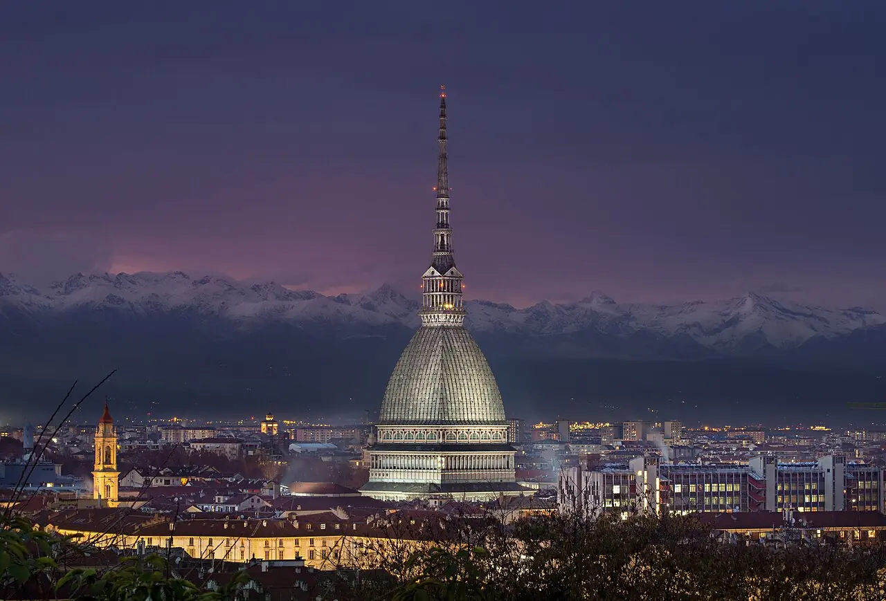 Mole Antonelliana (Turin, Piedmont, Italy) by night with Alps in the background