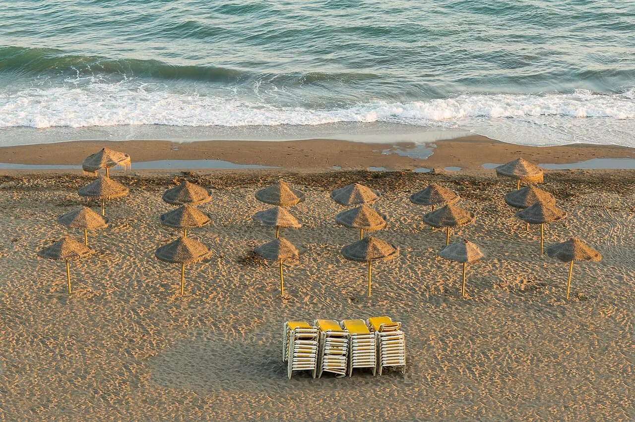 Parasols, Evening on the beach, Rincón de la Victoria , Andalusia , Spain .